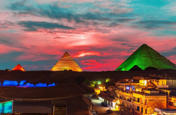 The Great Pyramid complex enlighted at night, Giza, Egypt.