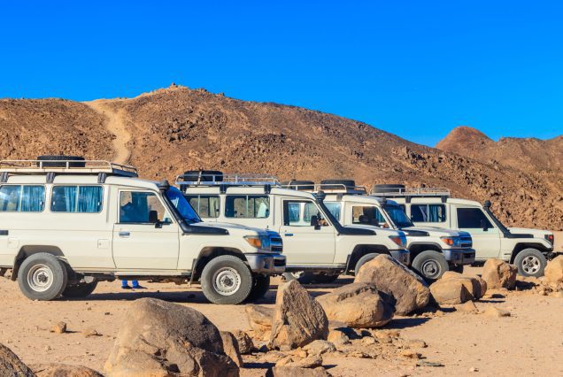Off road SUV cars in bedouin village in Arabian desert near Hurg
